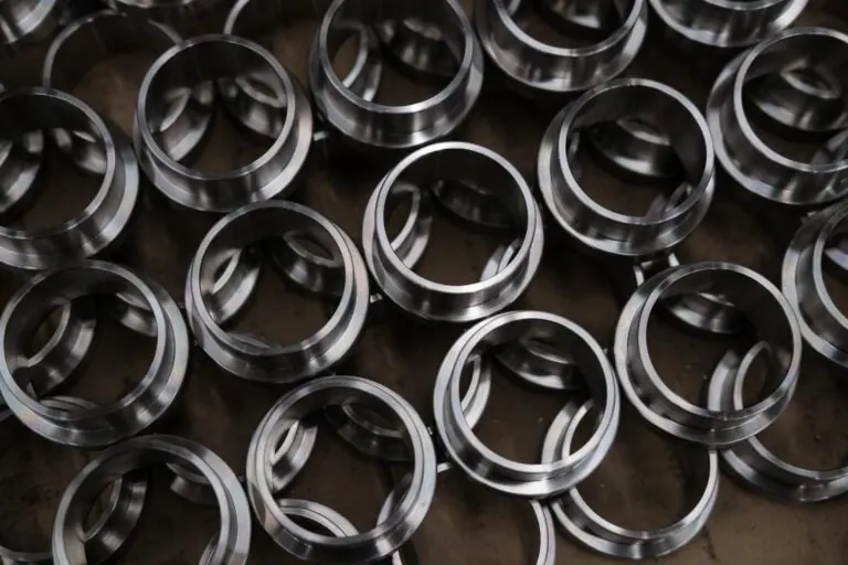 A production lot of turned stainless steel bushings, faced and chamfered