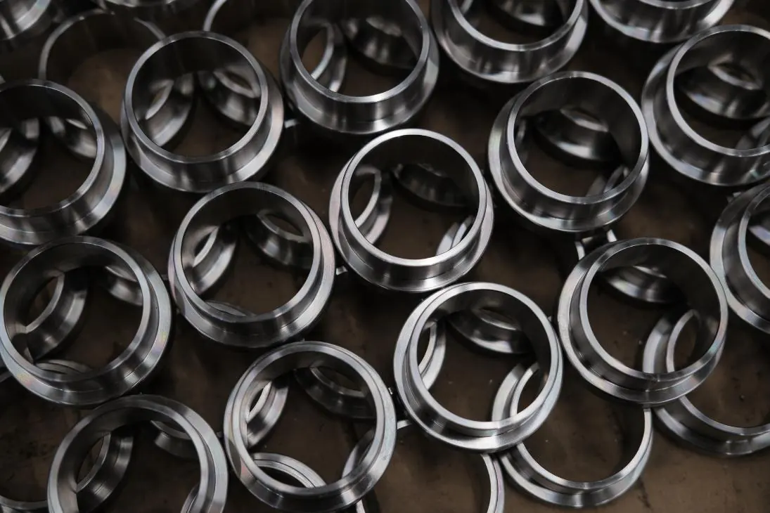 A production lot of turned stainless steel bushings, faced and chamfered