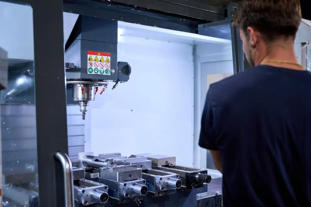 Machinist operating a CNC milling machine